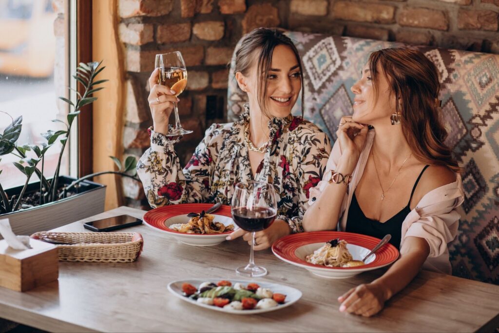 Friends eating pasta in an italian restaurant